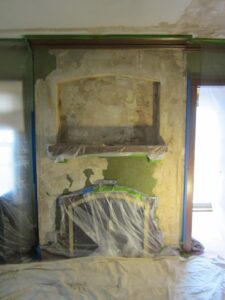 before image of fireplace plaster damage